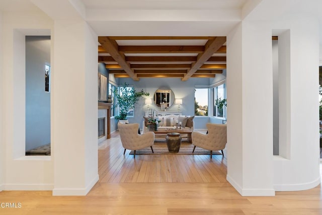 living room with hardwood / wood-style floors, coffered ceiling, and beam ceiling