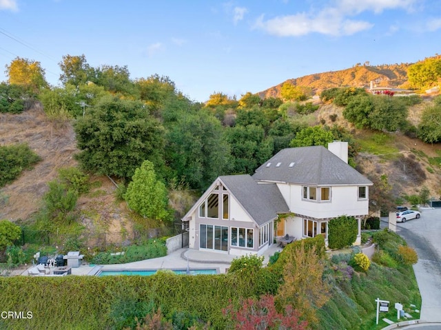 back of property with a mountain view