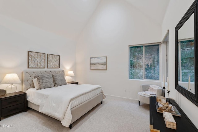 carpeted bedroom with high vaulted ceiling and multiple windows