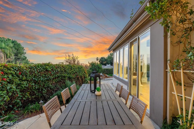 view of patio terrace at dusk