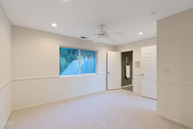 unfurnished room featuring light colored carpet and ceiling fan