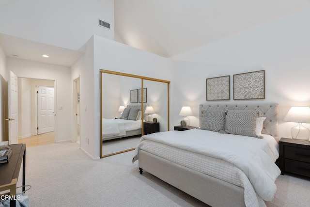 bedroom with light carpet and a closet