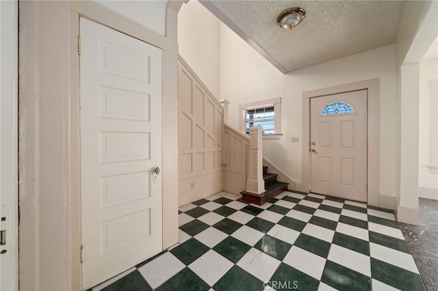 entrance foyer with a textured ceiling