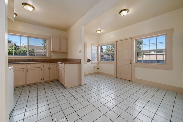 kitchen featuring light tile patterned floors, sink, and light brown cabinets