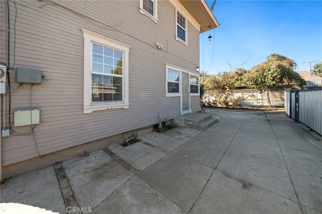 view of side of home with a patio area