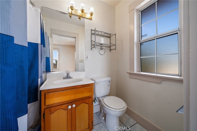 bathroom featuring toilet, tile patterned flooring, and vanity