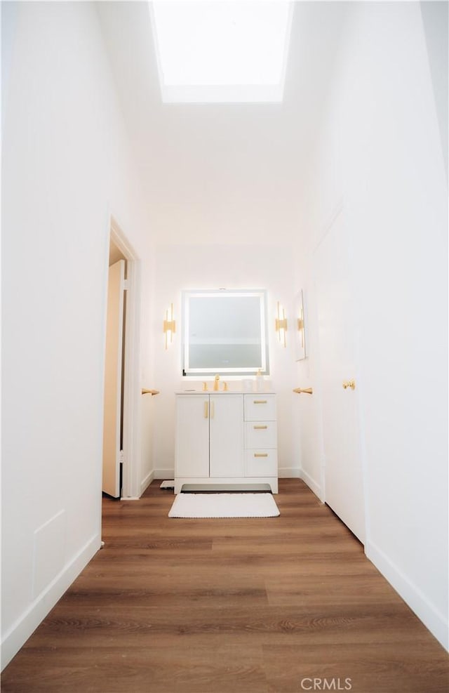 hallway with hardwood / wood-style floors