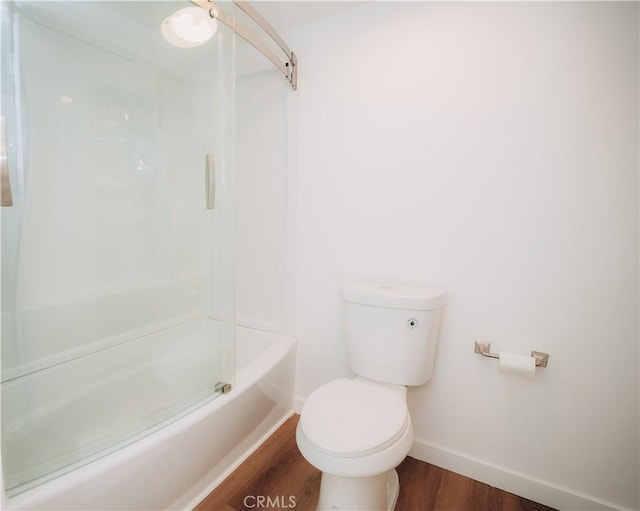 bathroom with hardwood / wood-style flooring, toilet, and shower / bathing tub combination