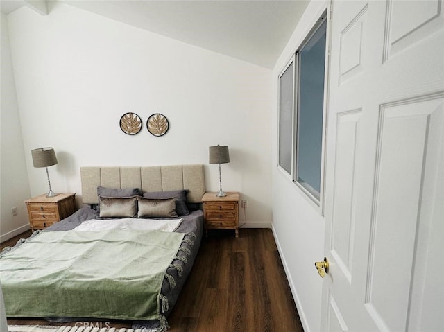 bedroom featuring lofted ceiling and dark wood-type flooring