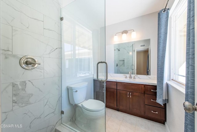 bathroom featuring toilet, vanity, and walk in shower