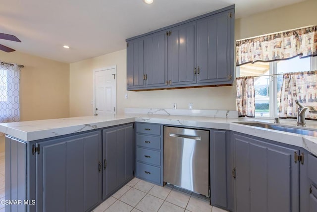 kitchen featuring ceiling fan, sink, stainless steel dishwasher, kitchen peninsula, and light tile patterned floors