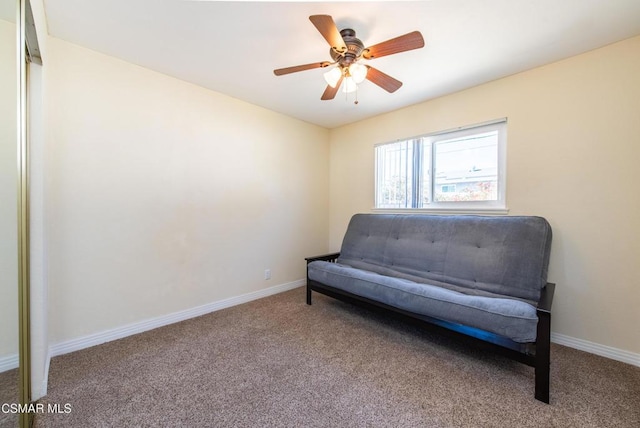 living area featuring ceiling fan and carpet floors