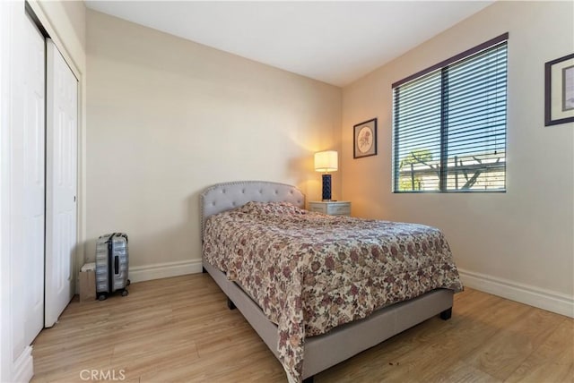 bedroom featuring light wood-type flooring and a closet