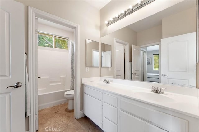 full bathroom featuring tile patterned floors, vanity, shower / tub combo, and toilet