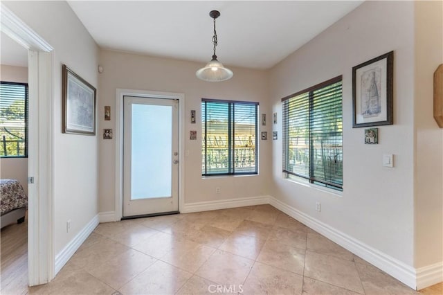 doorway featuring light tile patterned floors and a wealth of natural light