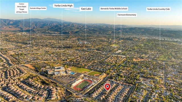 birds eye view of property with a mountain view