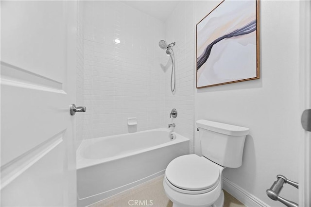 bathroom with tiled shower / bath combo and toilet