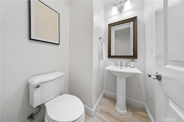 bathroom featuring toilet and hardwood / wood-style flooring