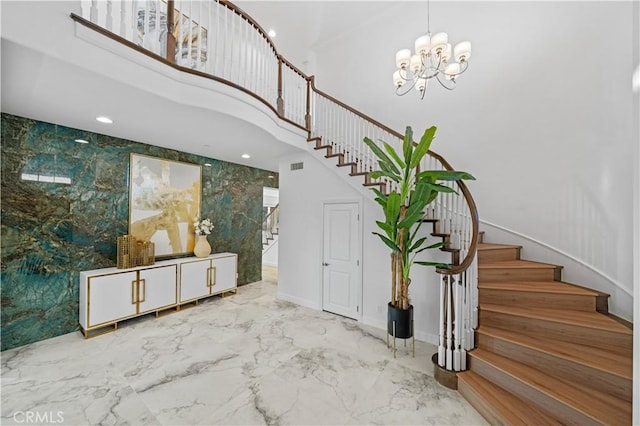 staircase featuring a chandelier and a towering ceiling