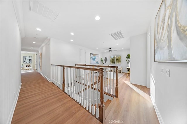 hall featuring ornamental molding and light wood-type flooring