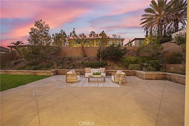 patio terrace at dusk featuring an outdoor hangout area