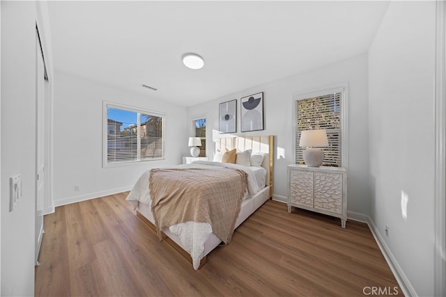 bedroom with hardwood / wood-style flooring