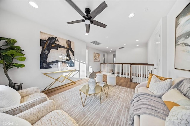 living room with ceiling fan and hardwood / wood-style floors