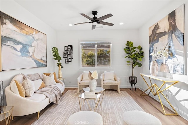 sitting room with hardwood / wood-style flooring and ceiling fan