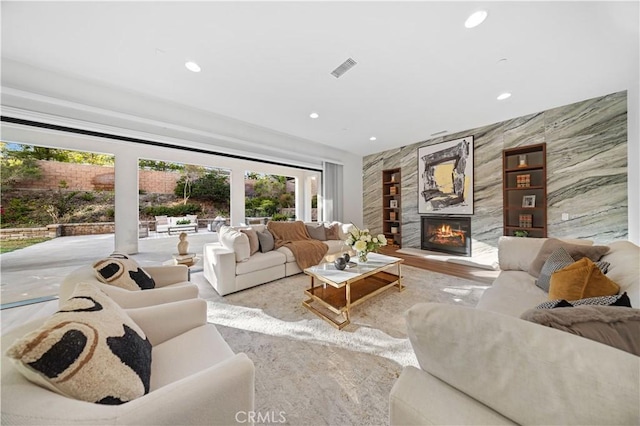 living room featuring a fireplace and tile walls