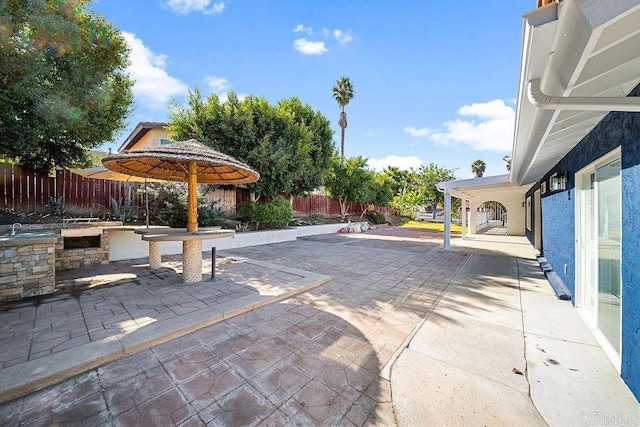 view of patio featuring exterior kitchen and sink