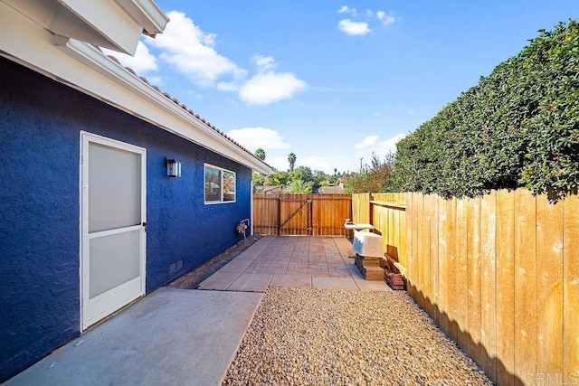 view of side of property featuring a patio area