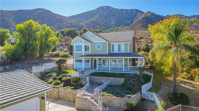 view of front of property with a mountain view and a porch