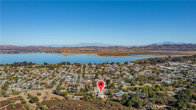 birds eye view of property featuring a water and mountain view