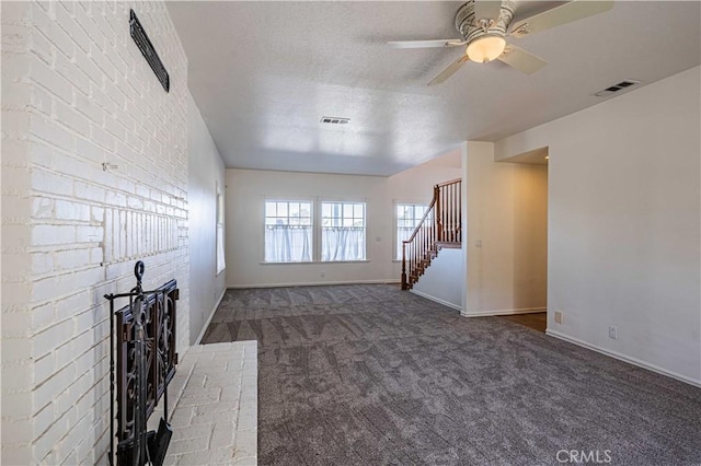 unfurnished living room with carpet flooring, ceiling fan, and a textured ceiling