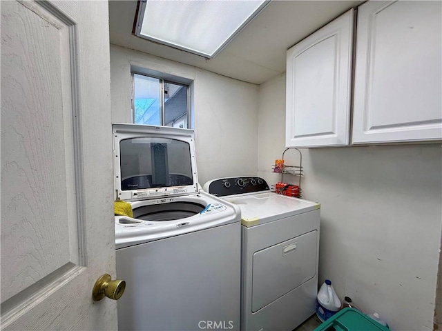 washroom with cabinets and independent washer and dryer