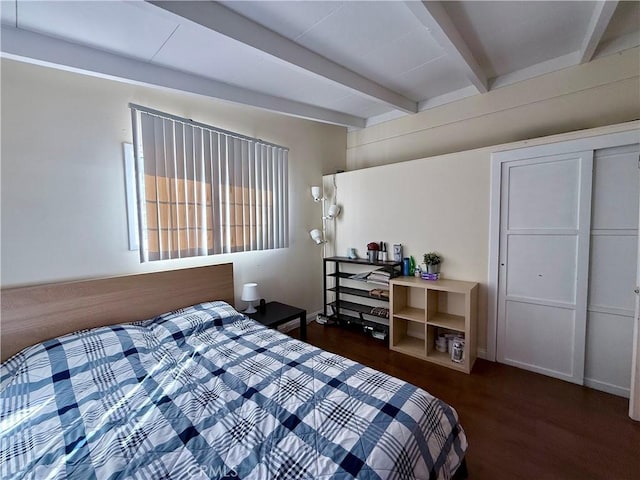 bedroom with beamed ceiling and dark hardwood / wood-style flooring