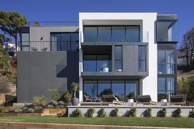 rear view of house with a balcony and a patio area