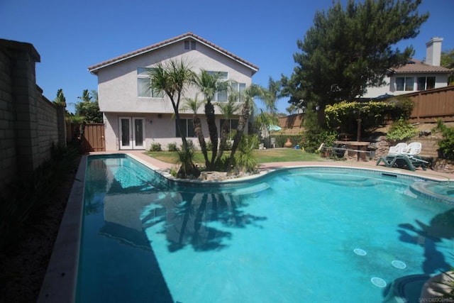 view of swimming pool featuring french doors