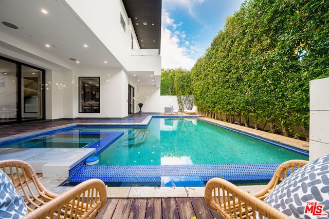 view of pool featuring an in ground hot tub