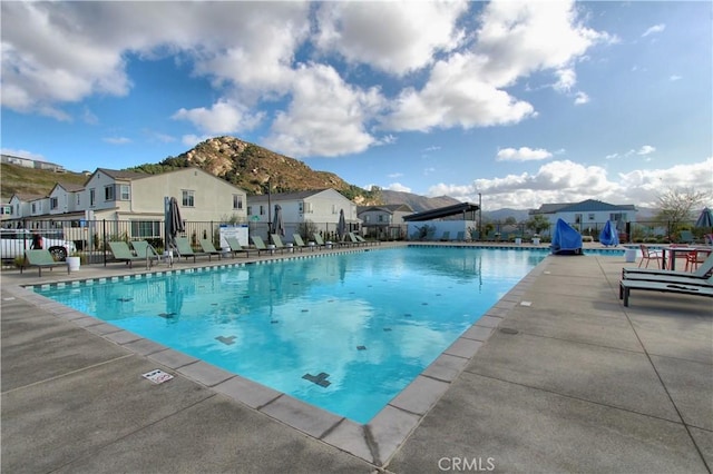 view of pool featuring a patio area and a mountain view