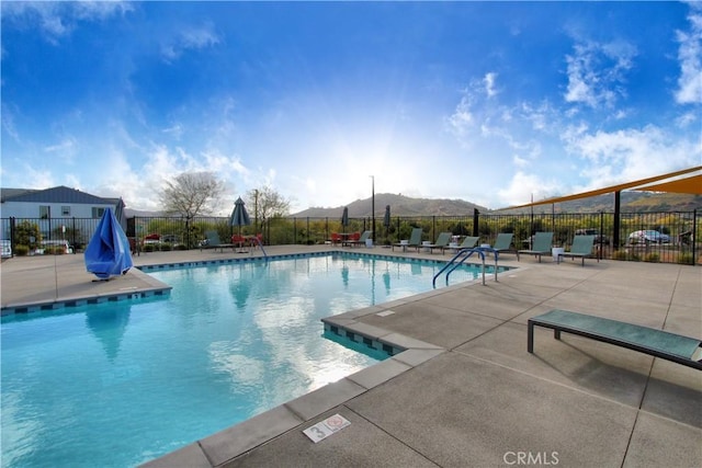 view of pool with a mountain view and a patio