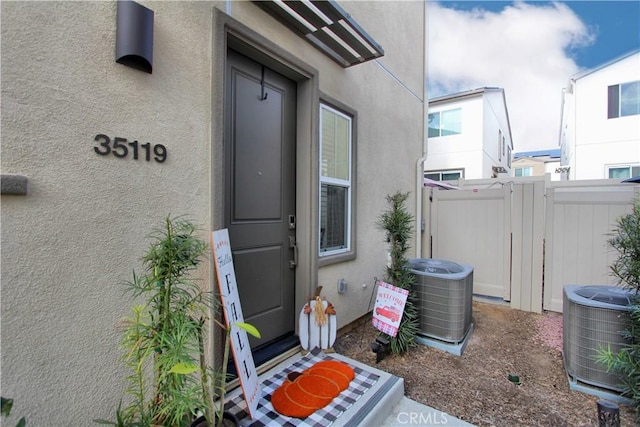 entrance to property featuring cooling unit