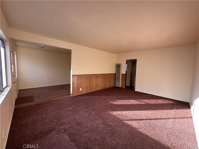 empty room featuring dark carpet