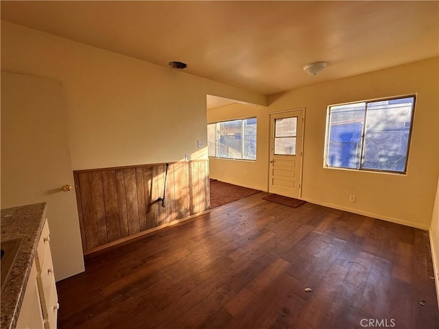 spare room with dark hardwood / wood-style flooring