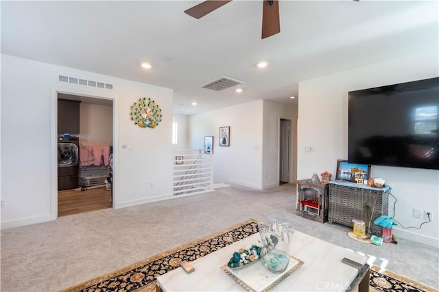 carpeted living room with washer / clothes dryer