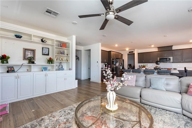 living room with ceiling fan and hardwood / wood-style flooring