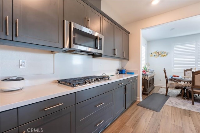 kitchen featuring light hardwood / wood-style floors and appliances with stainless steel finishes