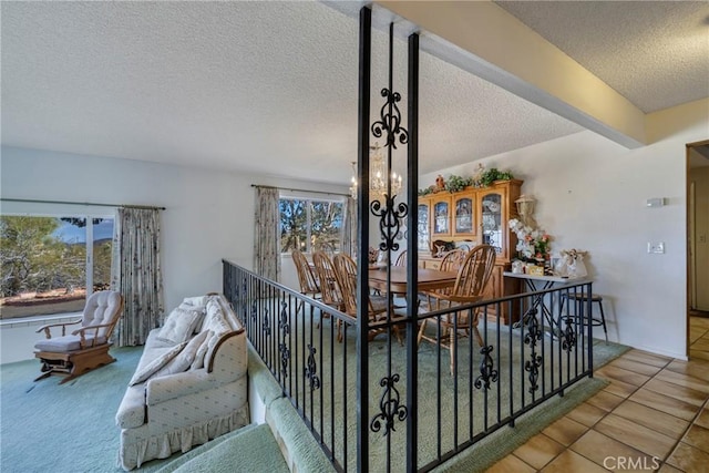 interior space with a textured ceiling, a healthy amount of sunlight, and tile patterned floors