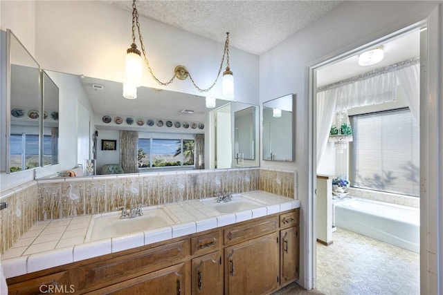 bathroom featuring vanity and a textured ceiling