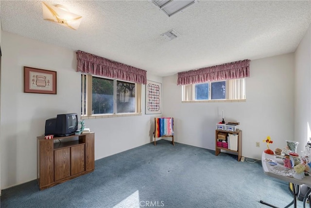 playroom with carpet flooring, a textured ceiling, and visible vents